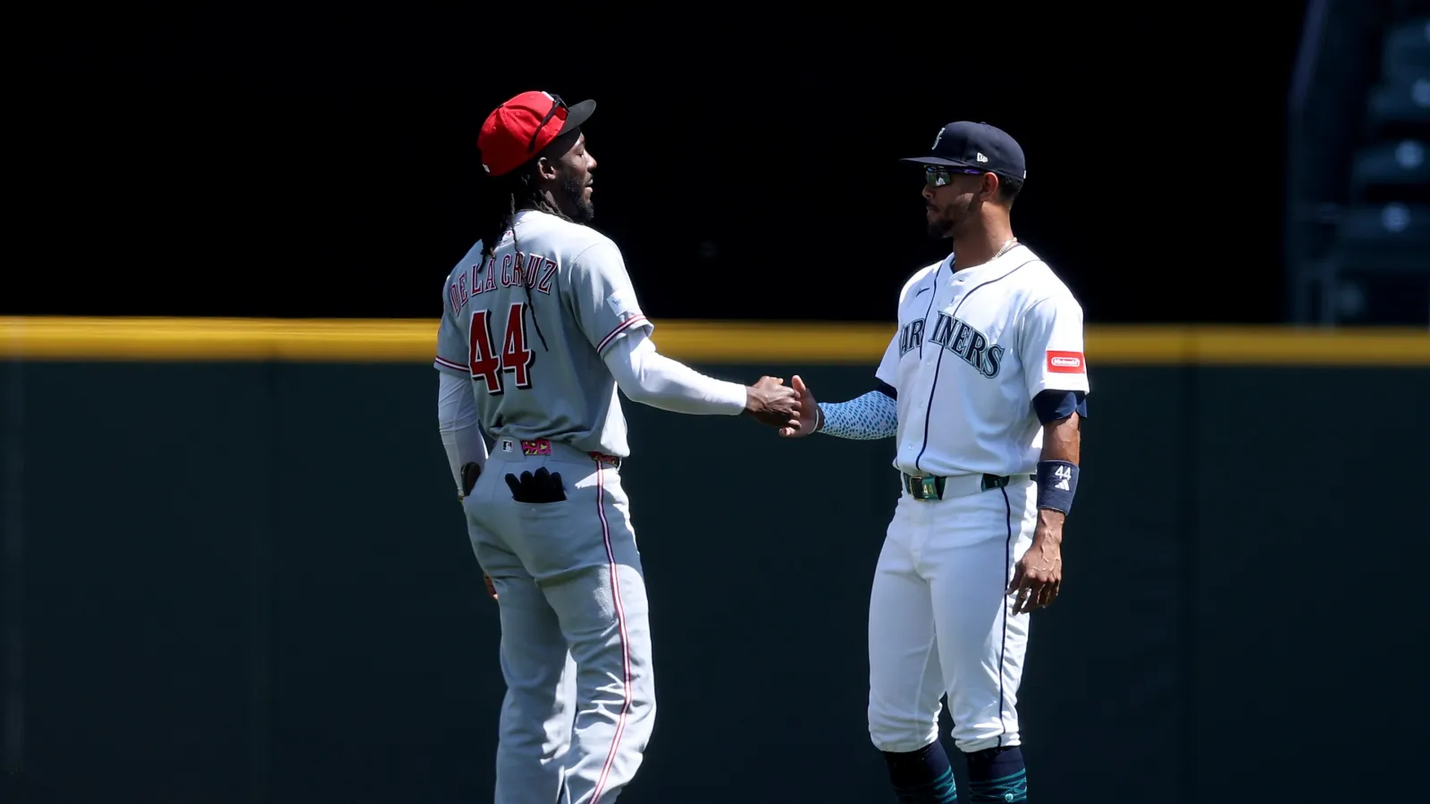 Elly de la Cruz #44 of the Cincinnati Reds and Julio Rodríguez #44 of the Seattle Mariners greet each other before the game at T-Mobile Park on July 22, 2026 in Seattle, Washington. (Photo by Steph Chambers/Getty Images)
