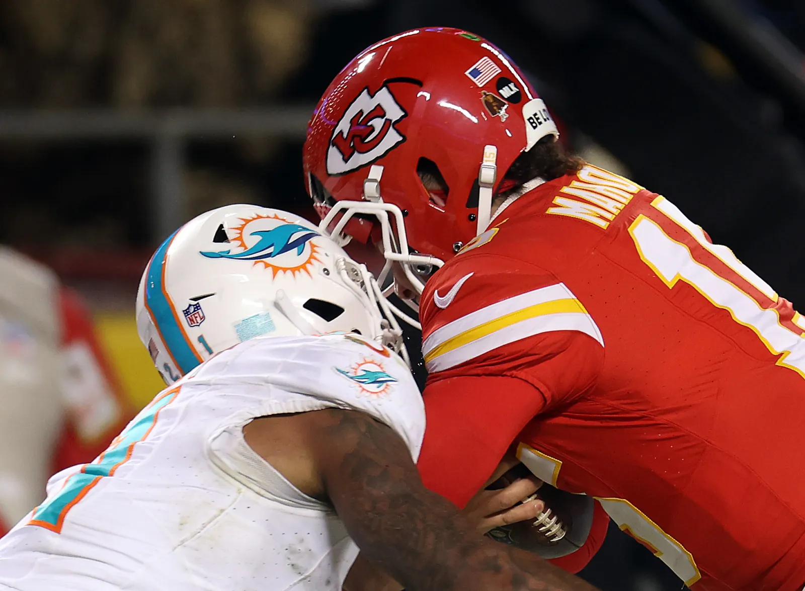 Safety DeShon Elliott #21 of the Miami Dolphins breaks the helmet of quarterback Patrick Mahomes as their helmets collide during the 2nd half of the AFC Wild Card Playoffs game at GEHA Field at Arrowhead Stadium on January 13, 2024, in Kansas City, Missouri. (Photo by Jamie Squire/Getty Images)