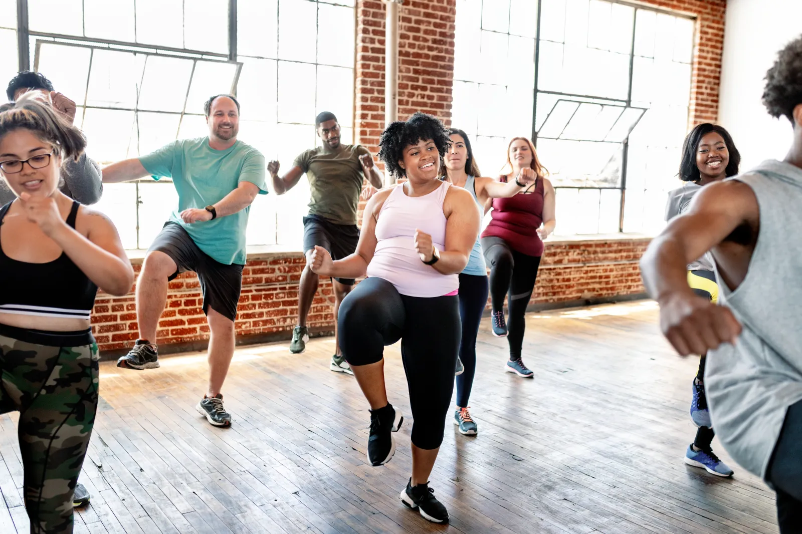 A stock image shows a group of people exercising together.