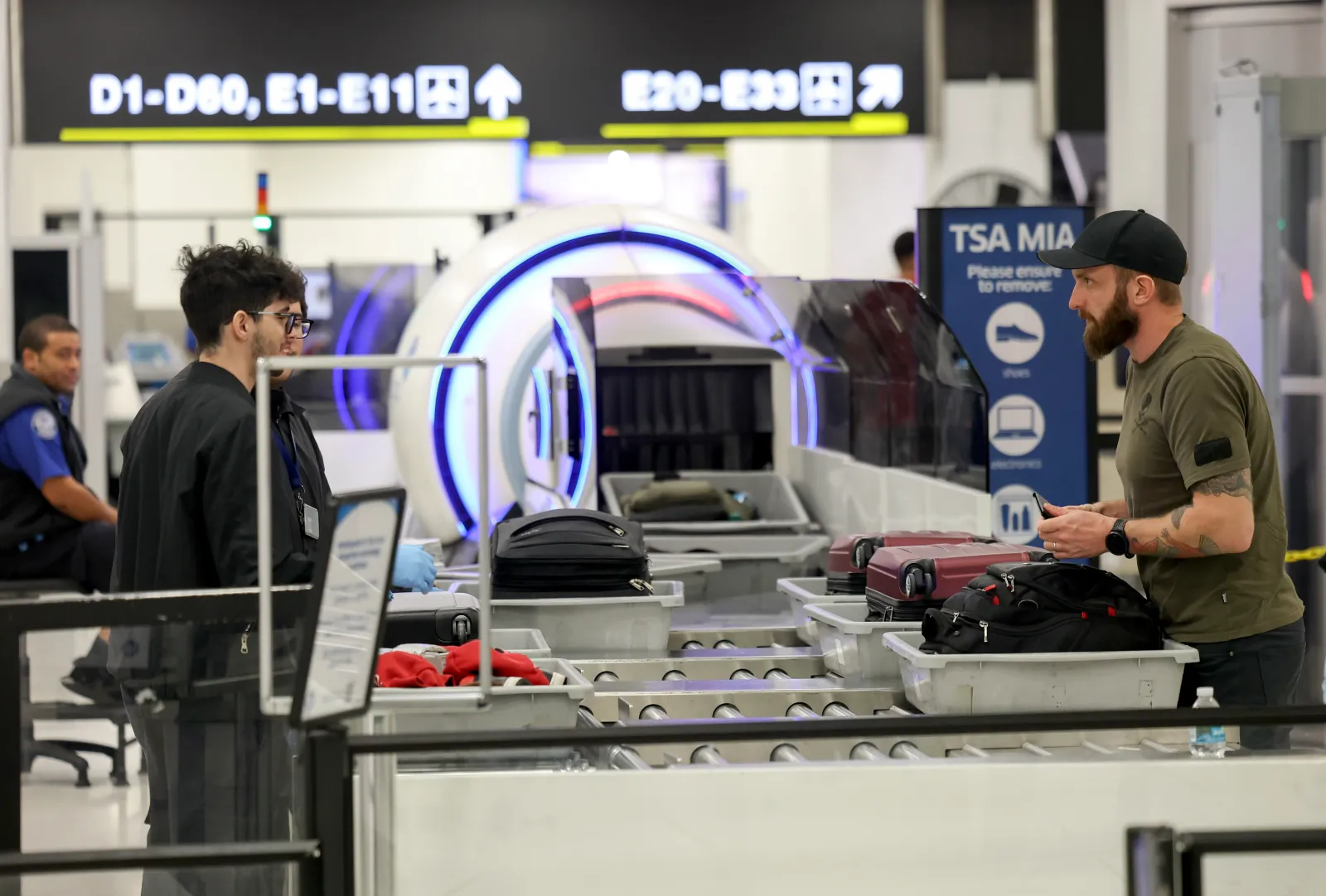 Travelers go through a TSA checkpoint at the Miami International Airport on December 20, 2024.