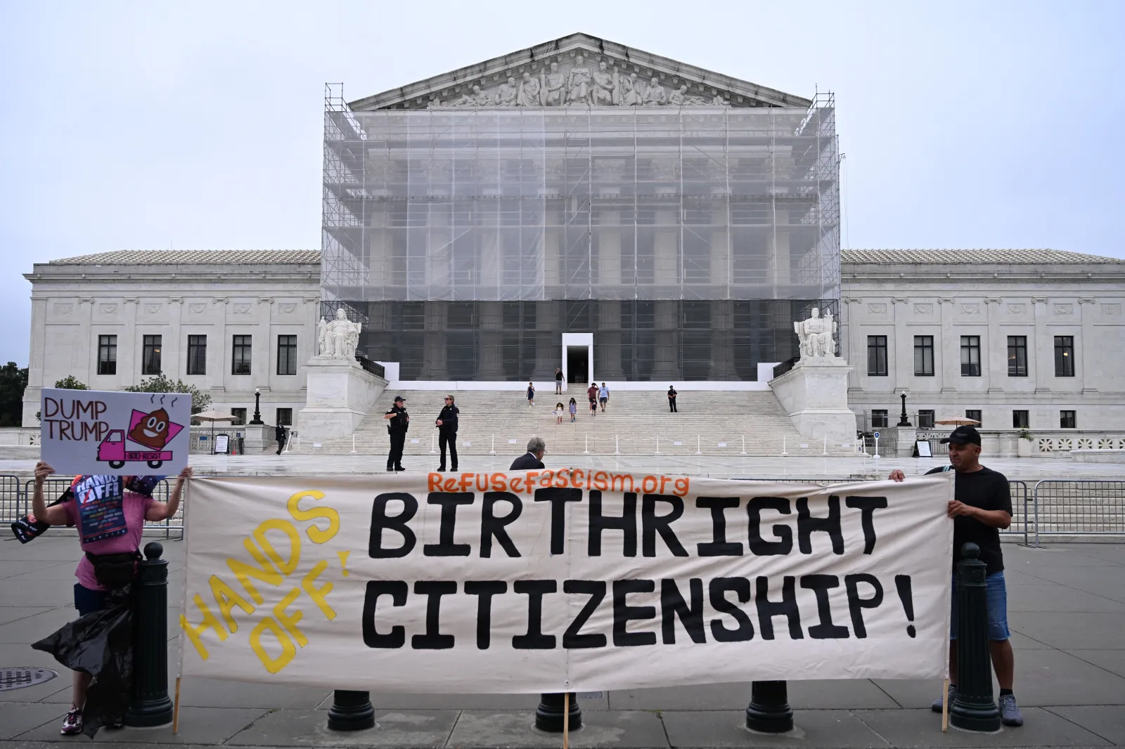 Demonstrators holds up an anti-Trump sign outside the U.S. Supreme Court in Washington, D.C., on June 27, 2025.