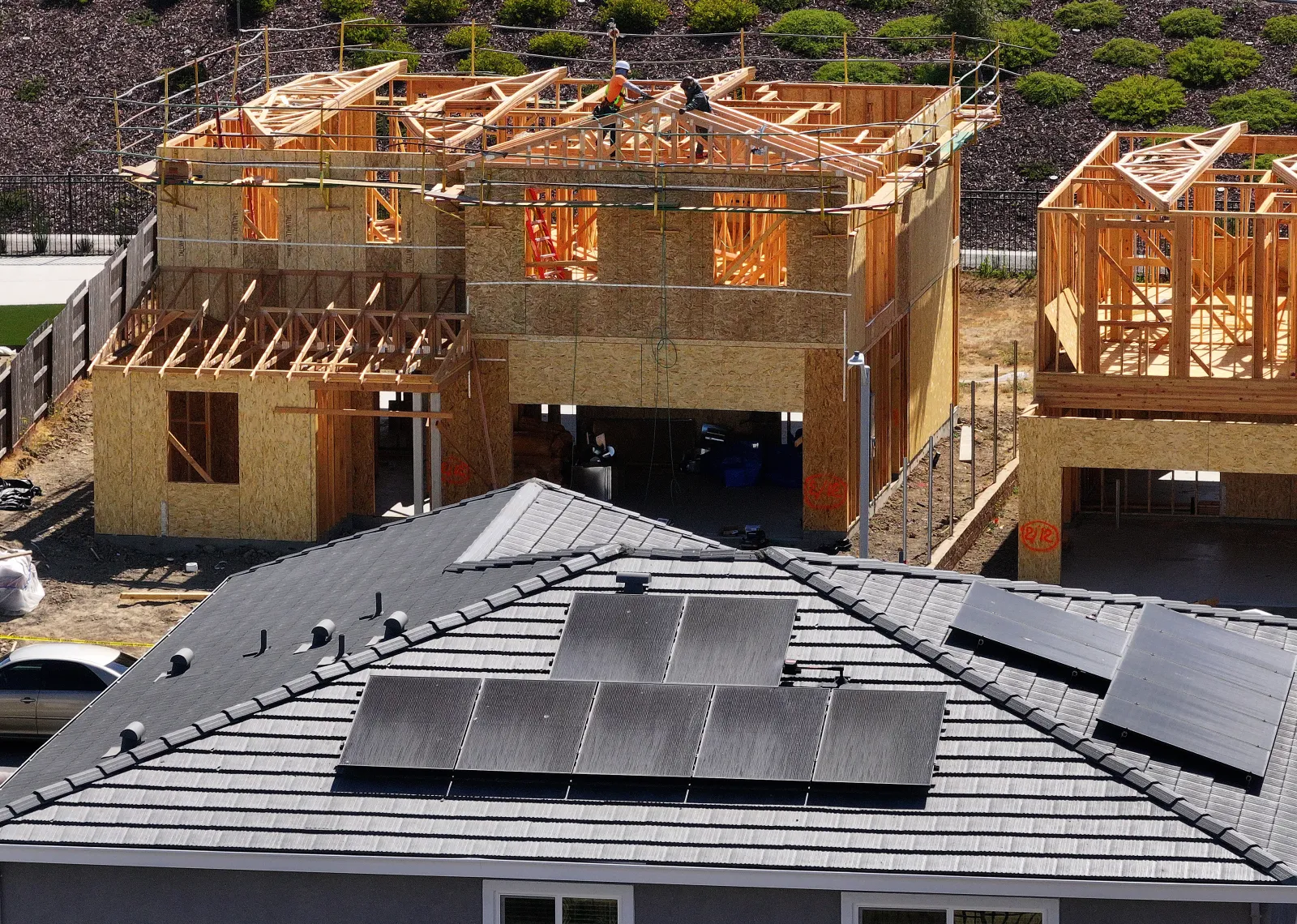 In an aerial view,  construction workers build a home at a new housing development on July 1, 2025 in Richmond, California.