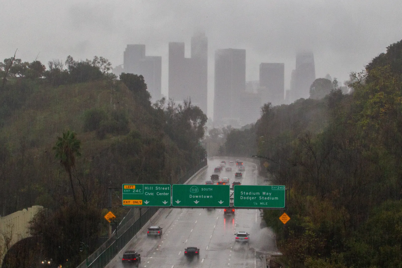 Cars ride the 110 Freeway toward downtown during heavy rain in Los Angeles, California, on November 15, 2025.