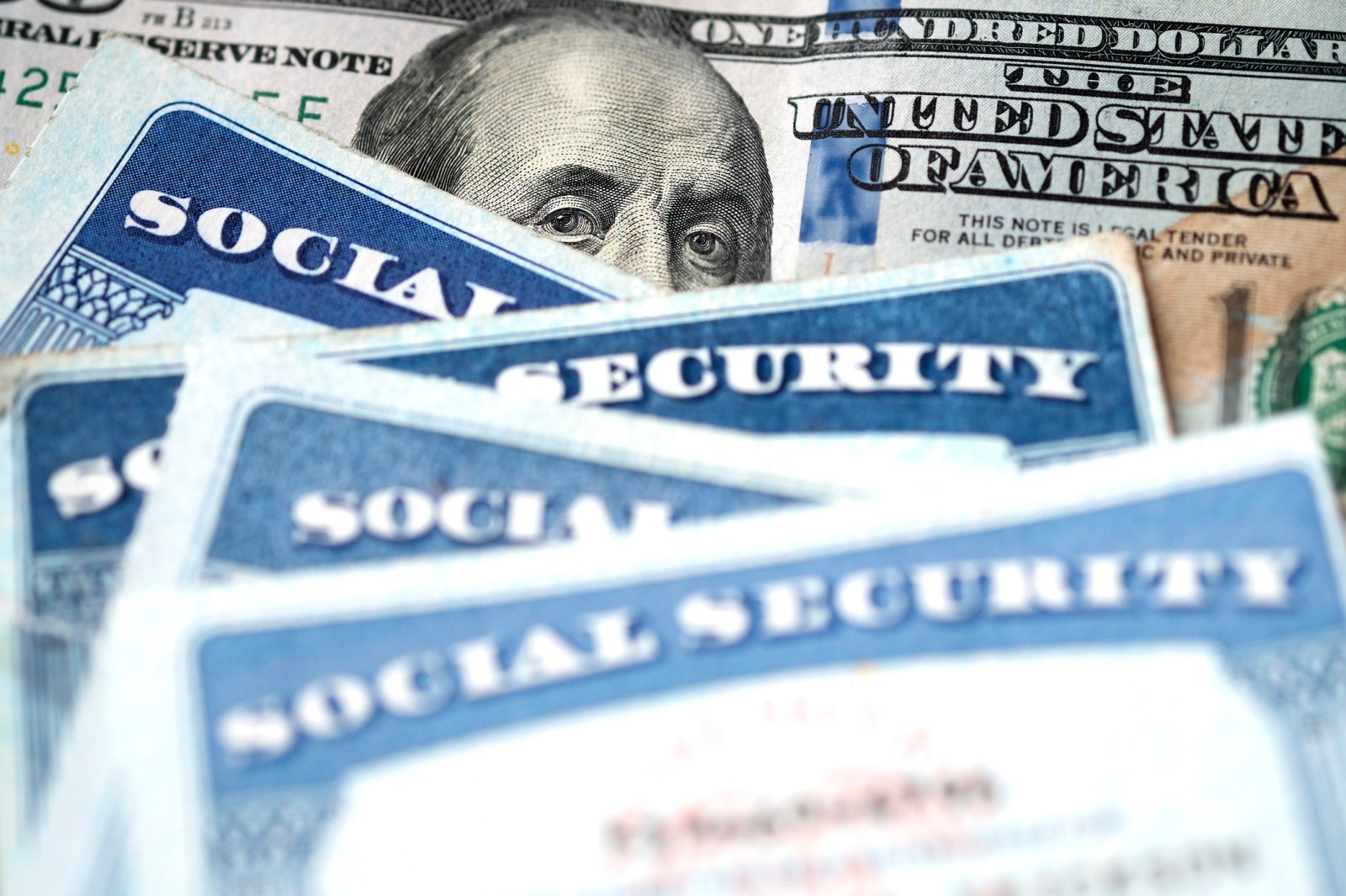 Stock image/file photo: Social Security cards with U.S. dollar bills.