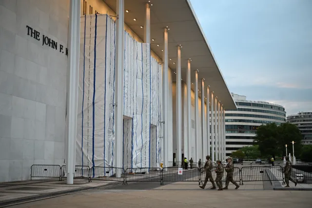 National Gaurd troops patrol outside the Kennedy Center, the facade covered with a tarp, in Washington, DC, on June 28, 2026.