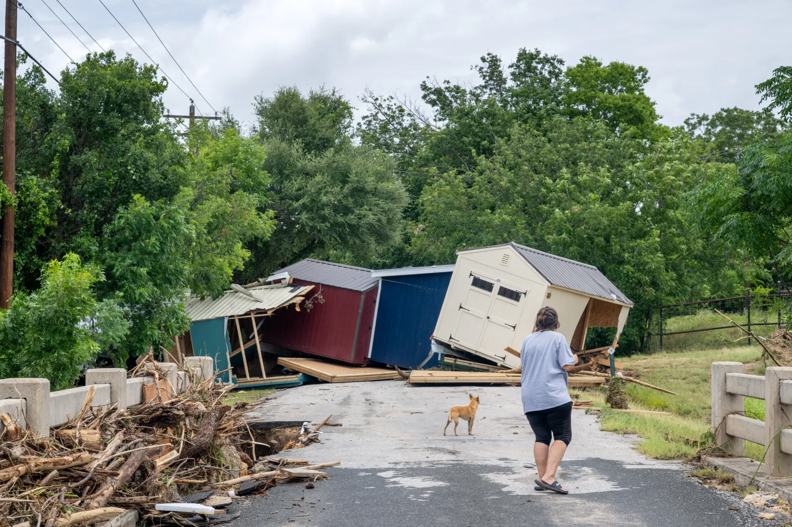 A person assess flood damage near the banks of the Guadalupe River on July 17 in Kerrville, Texas.