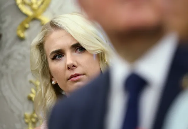 Trump aide Natalie Harp listens to a reporter's question for the president in the Oval Office of the White House on July 21, 2026.