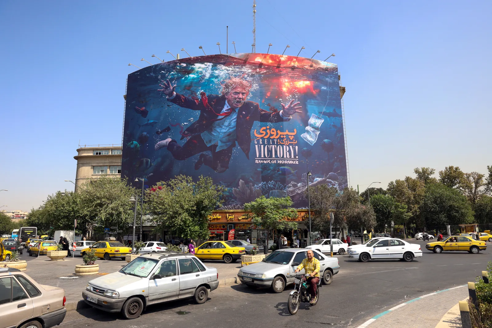 Motorists drive past an anti-US billboard in Tehran on August 24, 2026.