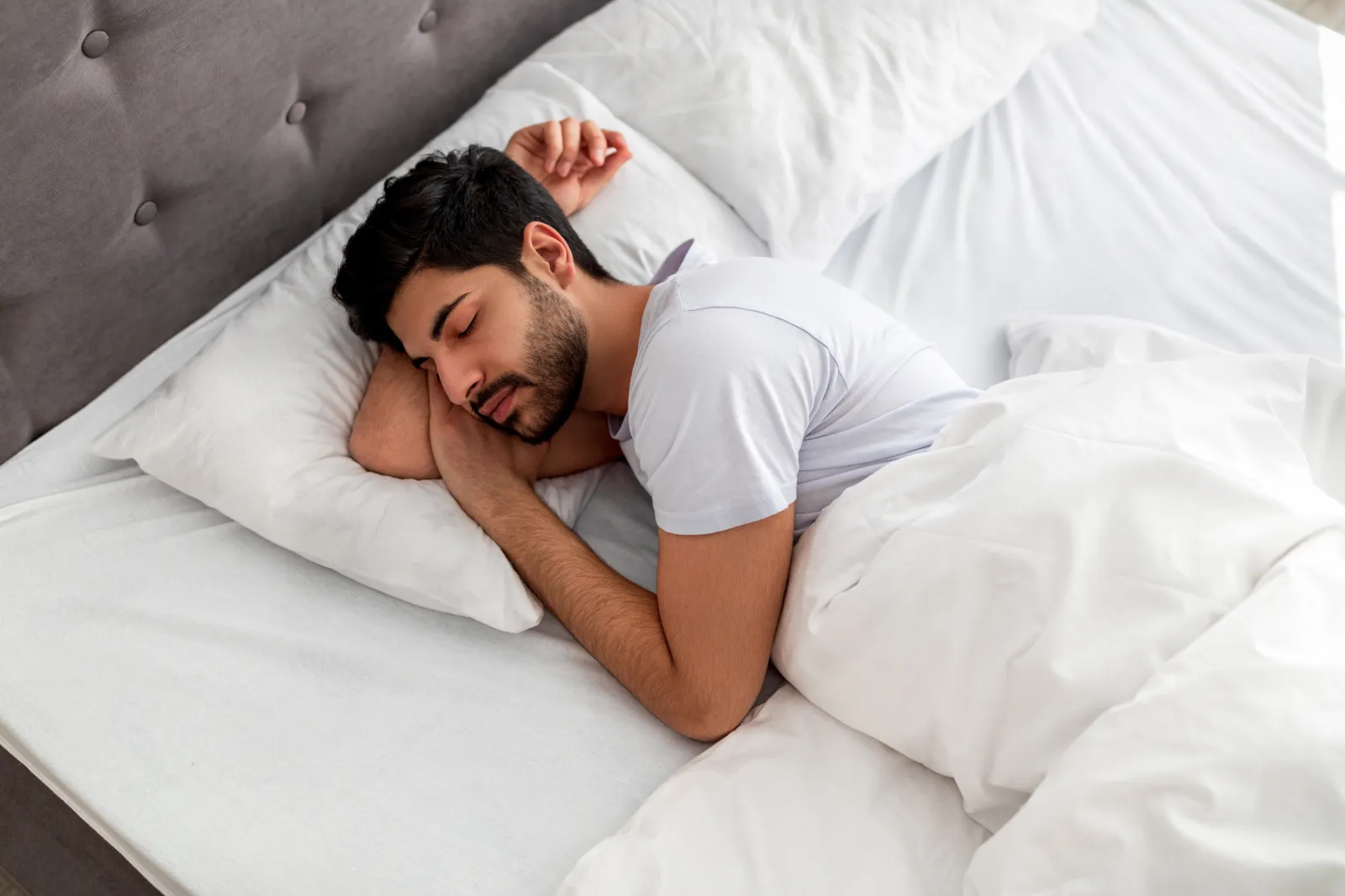 A young man sleeping in his bed.