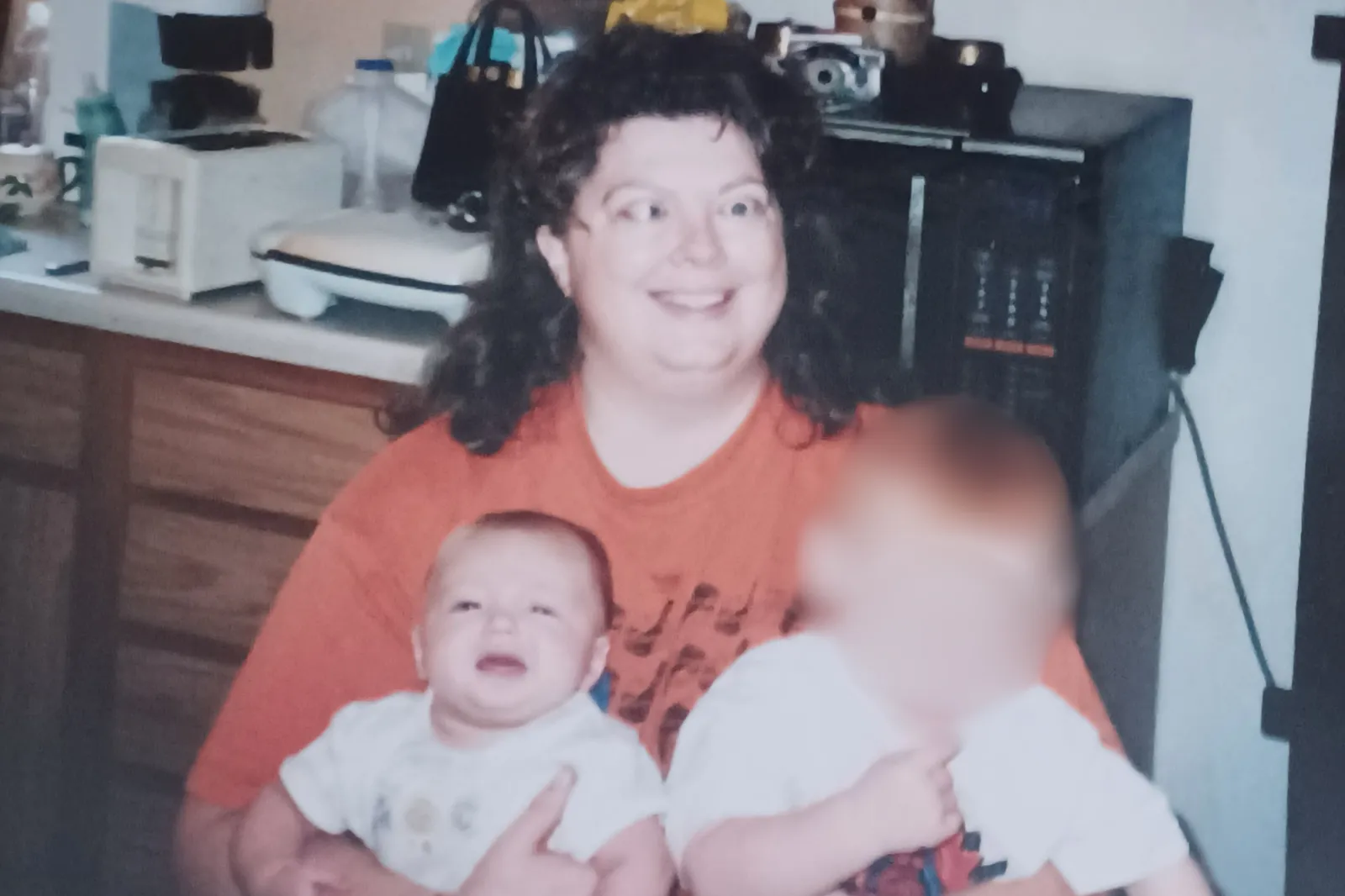 Debby holds her daughter Katie (left) and foster son (right), while in active TED.