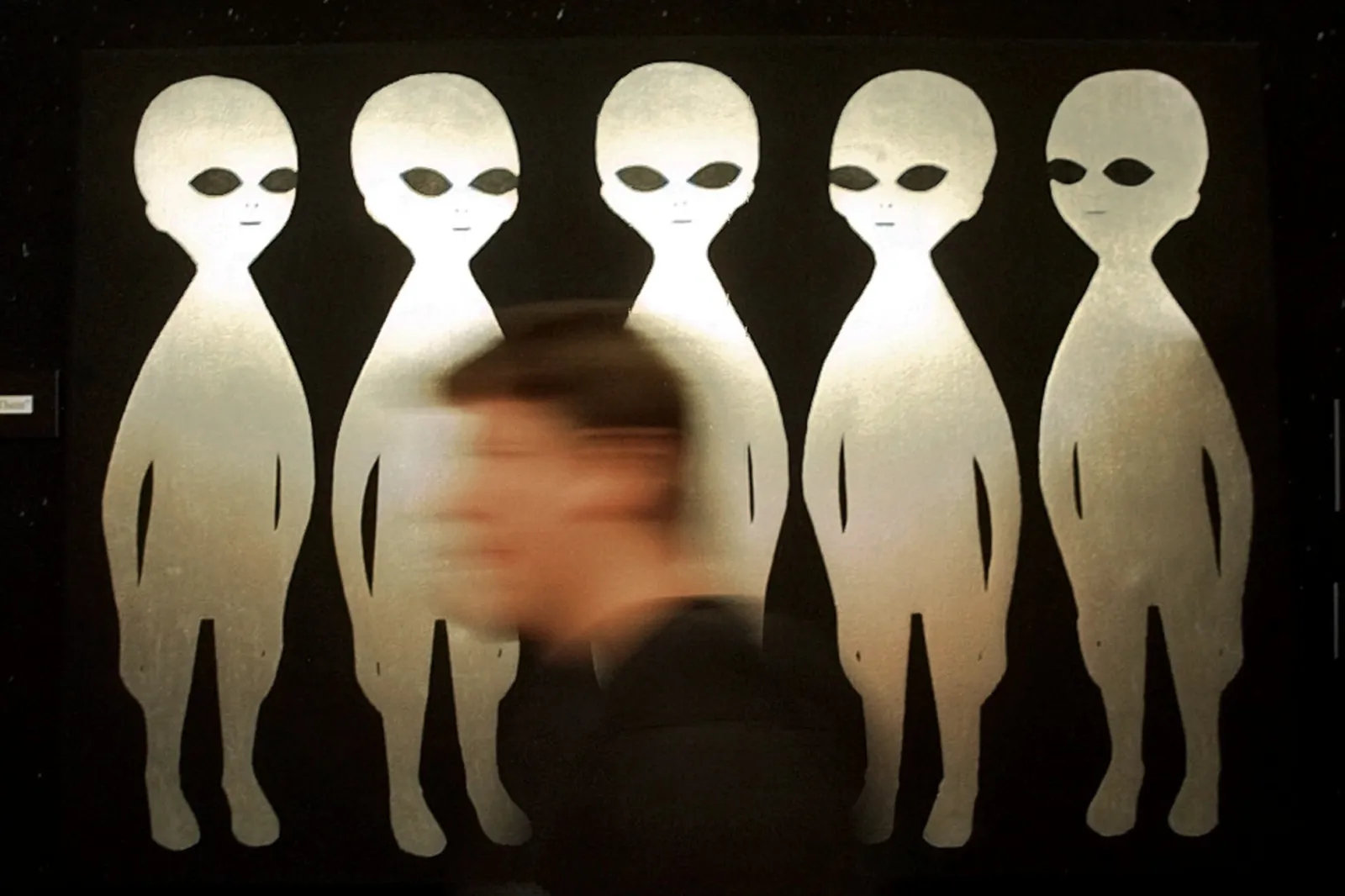 FILE - A patron passes a painting inside the International UFO Museum and Research Center in Roswell, N.M., on June 10, 1997. | AP Photo/Eric Draper, File