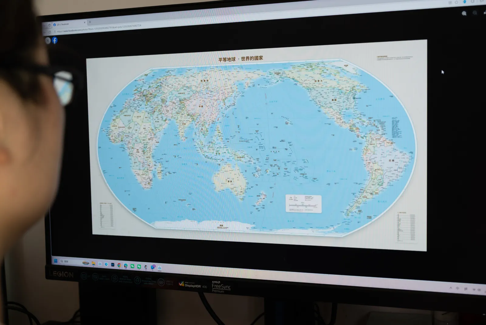 A man checks the "Equal Earth" map projection on a screen in Shanghai, China, on September 6, 2026. (FeatureChina via AP Images)
