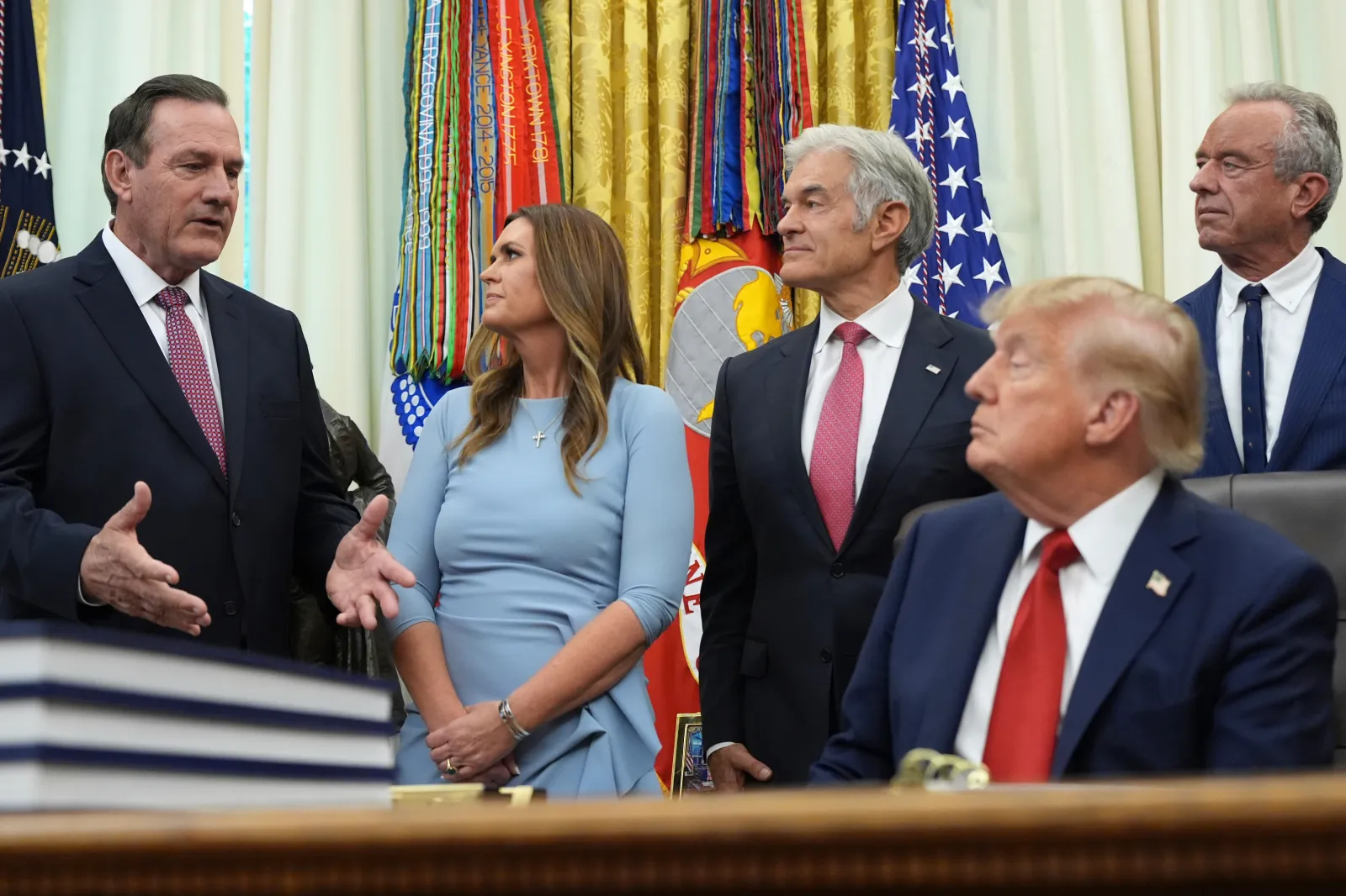 South Dakota Governor Larry Rhoden, left, speaks as Arkansas Governor Sarah Huckabee Sanders, CMS administrator Mehmet Oz, President Donald Trump and Health and