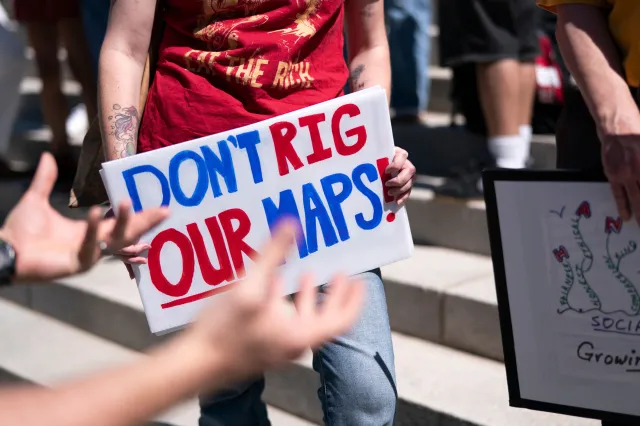 Demonstrators gather on the statehouse steps during a rally in opposition to congressional redistricting on May 14, 2026 in Columbia, South Carolina.