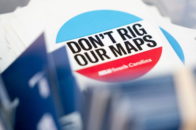 A pile of stickers from ACLU South Carolina are shown during a rally in opposition to congressional redistricting on May 14, 2026 in Columbia, South Carolina.