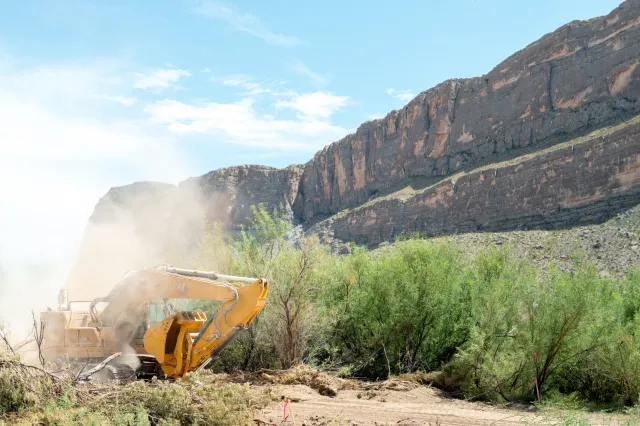 An excavator plows through land during construction for a section of border wall near Santa Elena Canyon on August 14, 2026 in Big Bend National Park, Texas.