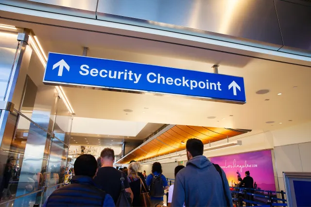 File photo: people wait in line at the entrance of the security checkpoint in LAX airport in Los Angeles in October 2018.