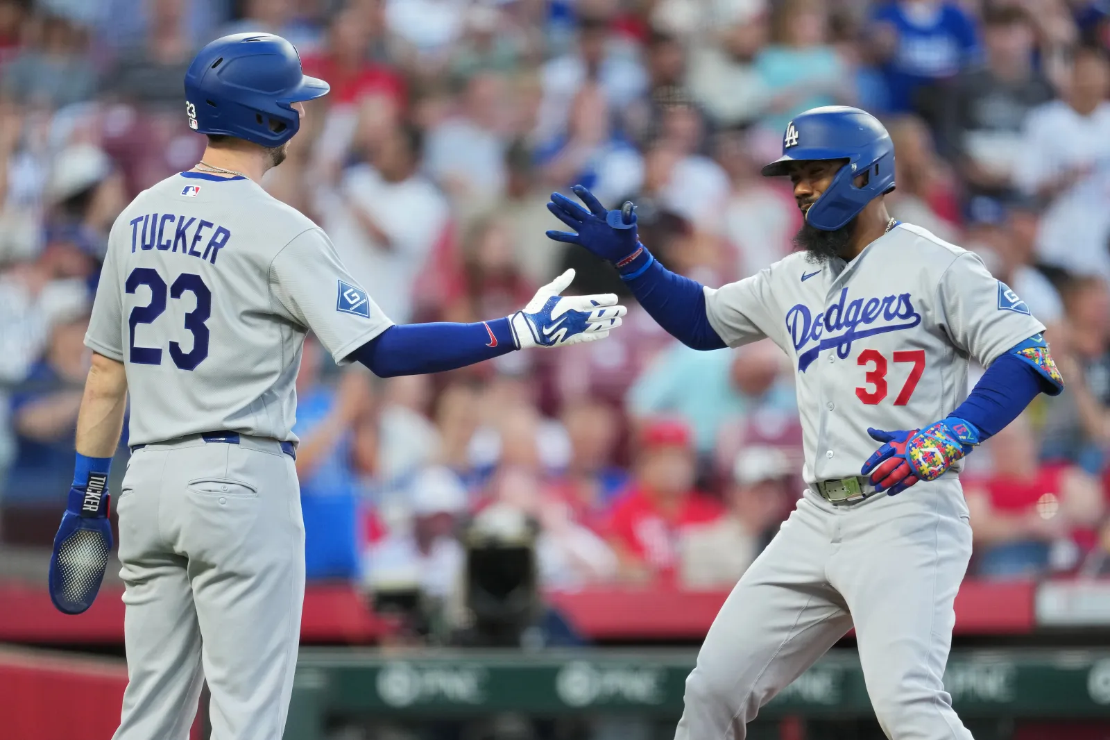 Teoscar Hernández #37 of the Los Angeles Dodgers celebrates with teammate Kyle Tucker #23 after hitting a two-run home run during the fourth inning of a basebal