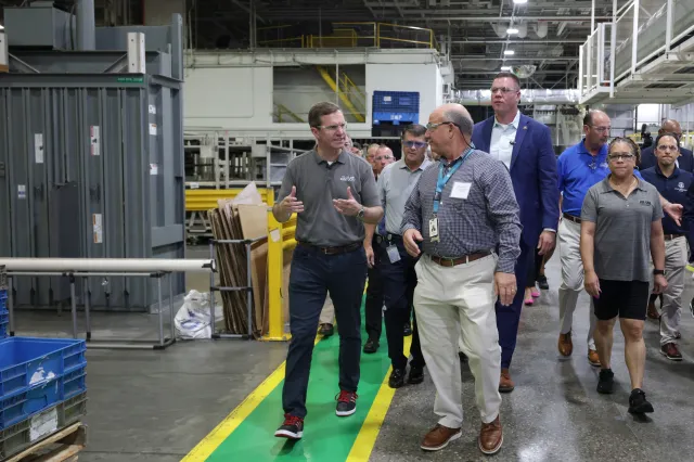 Kentucky Governor Andy Beshear and Vice President of Manufacturing at GE Appliances, Bill Good, tour the laundry plant at Appliance Park headquarters of GE Appliances on August 13, 2025, in Louisville, Kentucky.