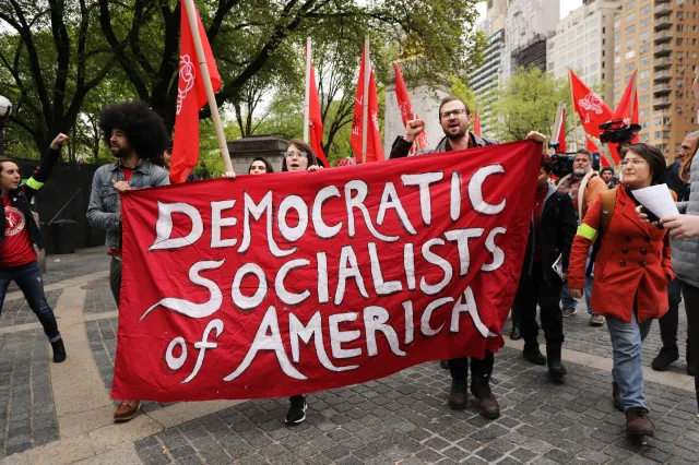 Democratic Socialists of America gather outside of a Trump-owned building in New York City on May 1, 2019.
