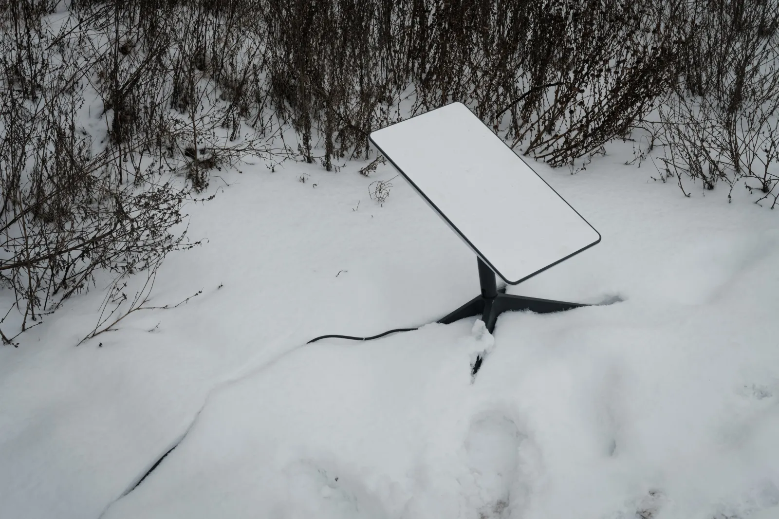 The antenna of the Starlink satellite-based broadband system is seen in the snow in Bakhmut, Ukraine, on February 16, 2023.