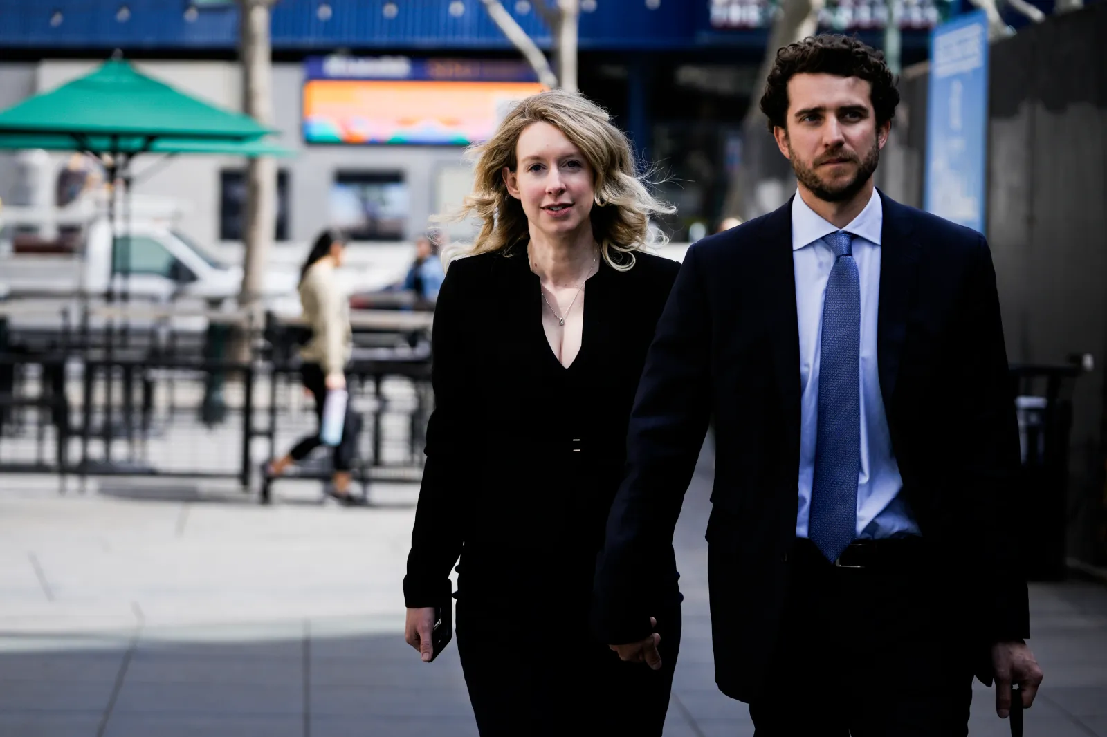 Former Theranos CEO Elizabeth Holmes alongside her boyfriend Billy Evans walks back to her hotel following a hearing at the Robert E. Peckham U.S. Courthouse on