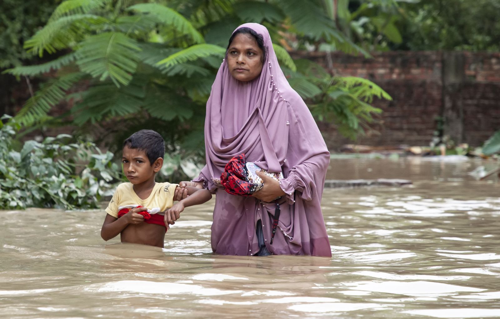 August 9, 2023, Chittagong, Bangladesh: Pedestrians walk through flooded roads in Satkania Upazila of South Chittagong, Bangladesh, in chest and waist level wat