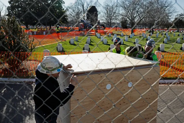 Contractors close a crate while working to dismantle and remove the Confederate Memorial in Section 16 at Arlington National Cemetery on December 20, 2023, in Virginia.