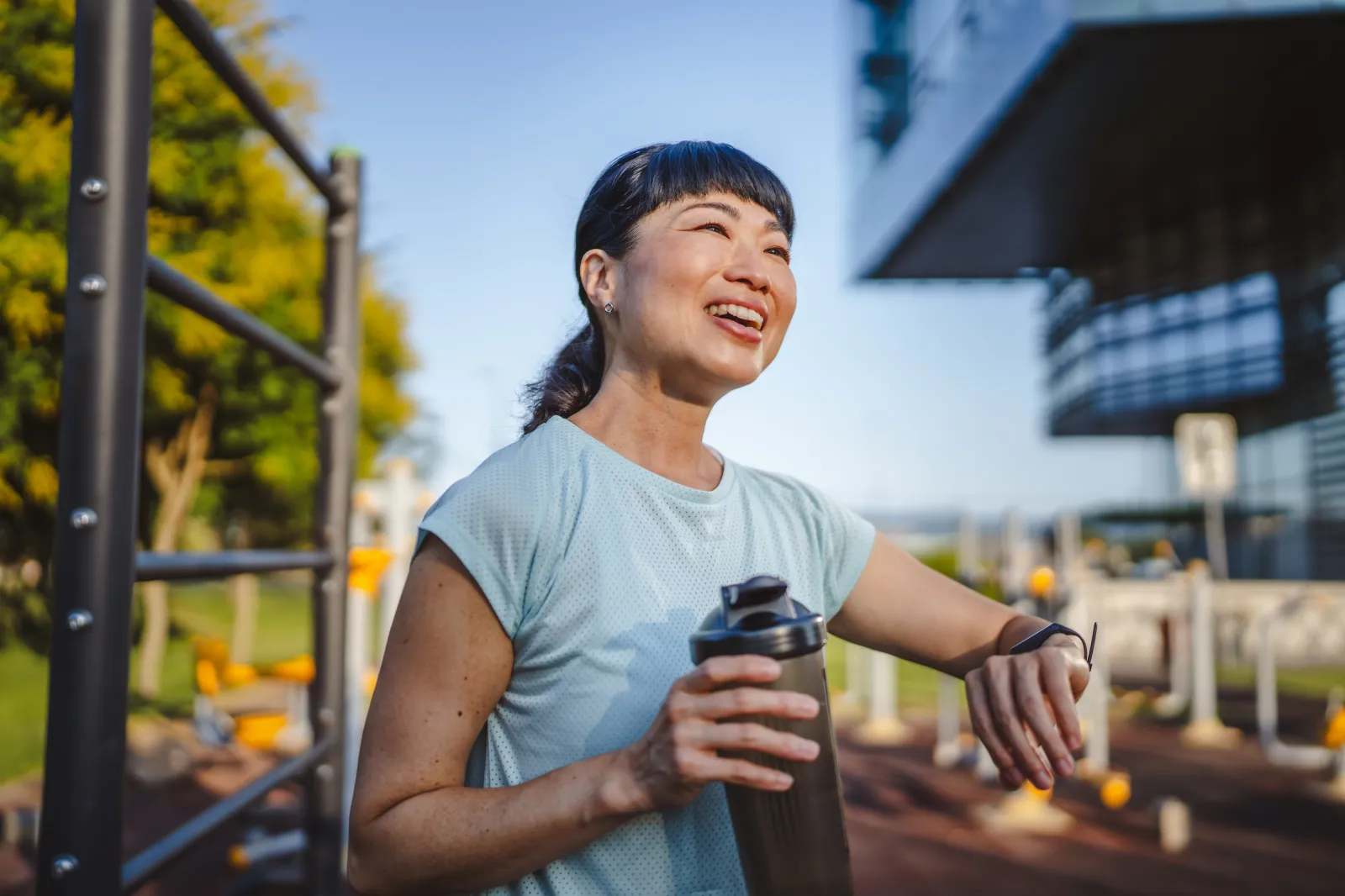 Stock photo: A mature Asian woman pauses on a run.