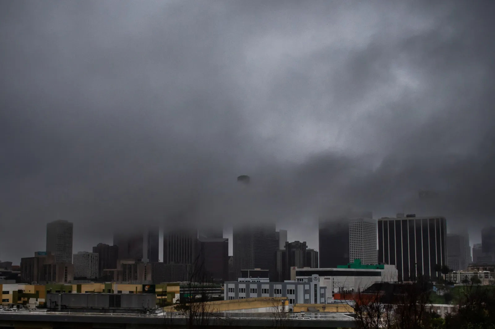 Heavy rain and clouds cover downtown Los Angeles, as seen from Echo Park, on December 24, 2025.
