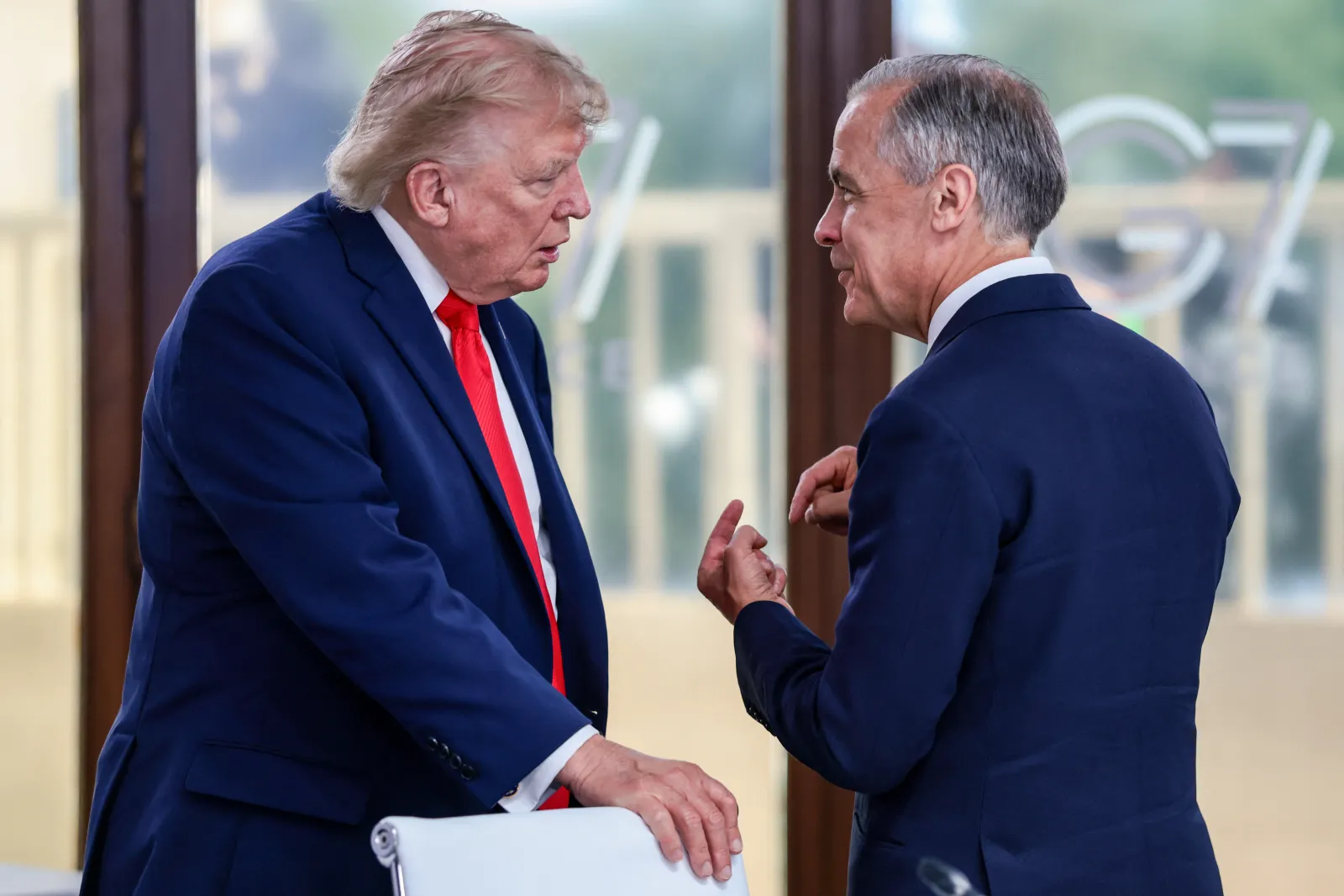US President Donald Trump speaks with Canada's Prime Minister Mark Carney during a work lunch as part of the G7 summit, in Evian, eastern France, on June 16, 2026. (Photo by Evelyn Hockstein / POOL / AFP via Getty Images)