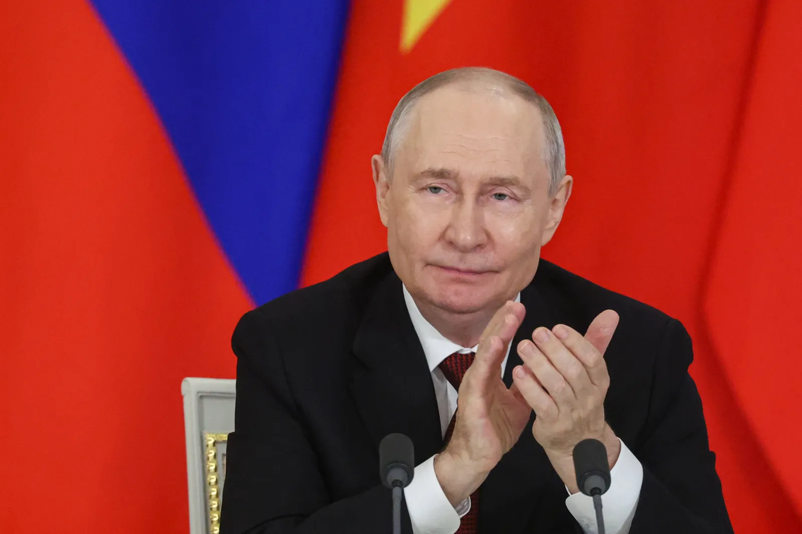 Russia's President Vladimir Putin applauds during the signing of documents following his talks with Vietnamese president in Moscow on September 9, 2026.