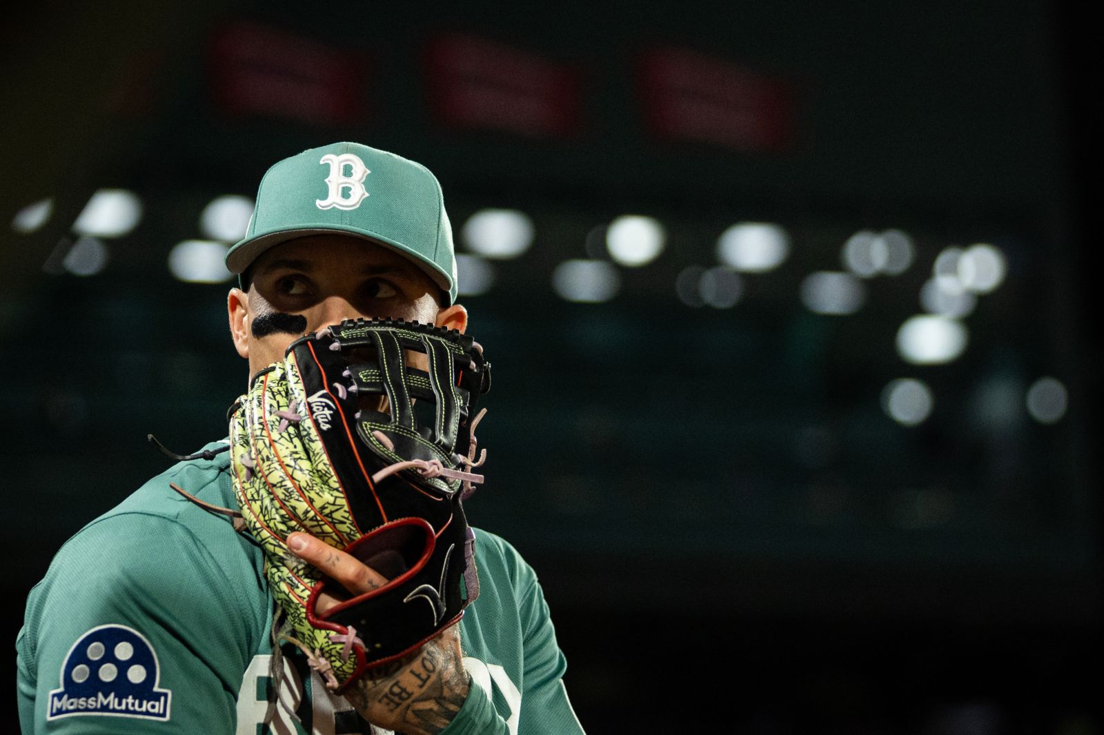 Jarren Duran #16 of Boston Red Sox covers his face and enters the field during the top of the seventh inning of a game against the Kansas City Royals at Fenway