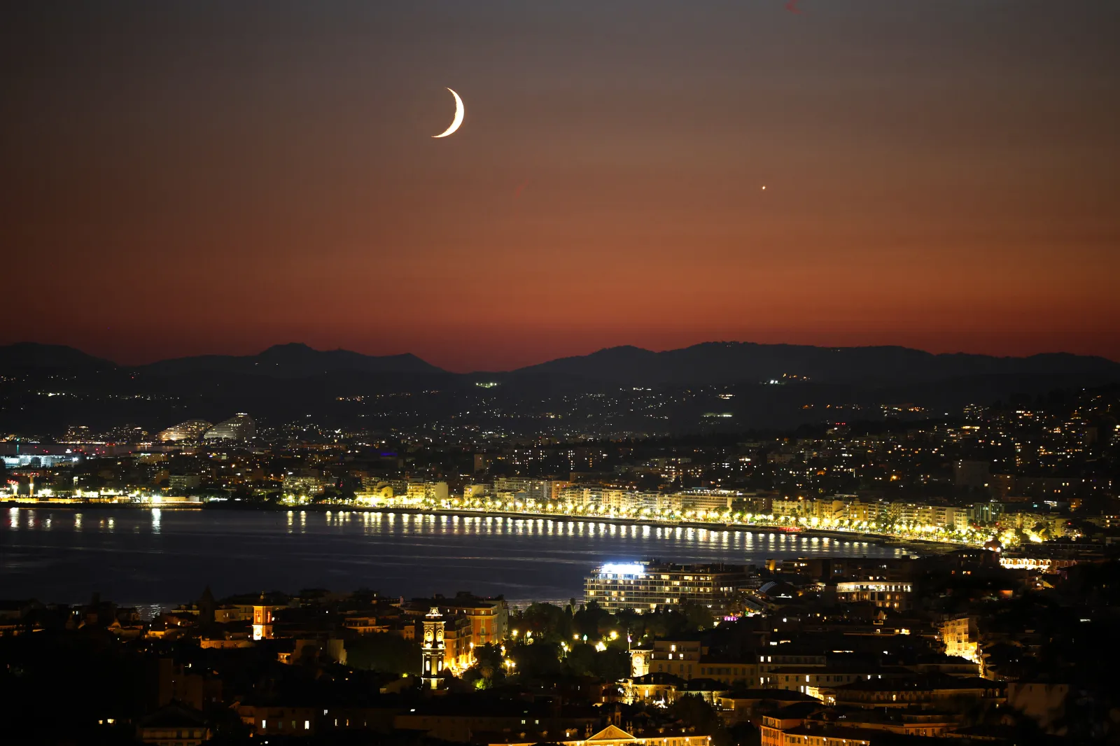 This photograph shows a waxing crescent moon and Venus (right) at sunset over the "Baie des anges" on the French riviera city of Nice, on September 14.