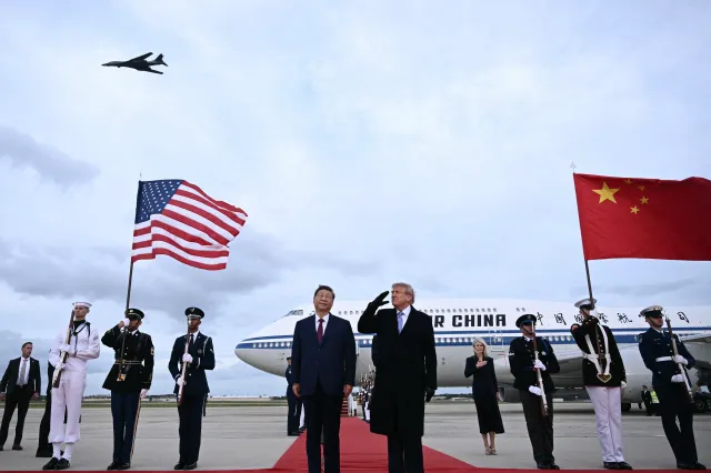President Donald Trump salutes as a B-1 bomber flies past as he greeted Chinese President Xi Jinping at Joint Base Andrews in Maryland on September 23, 2026.
