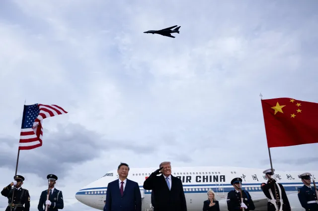 President Donald Trump reacts as a B-1 bomber flies overhead during the playing of the U.S. national anthem at an arrival ceremony for Chinese President Xi Jinping at Joint Base Andrews in Maryland on September 23, 2026.