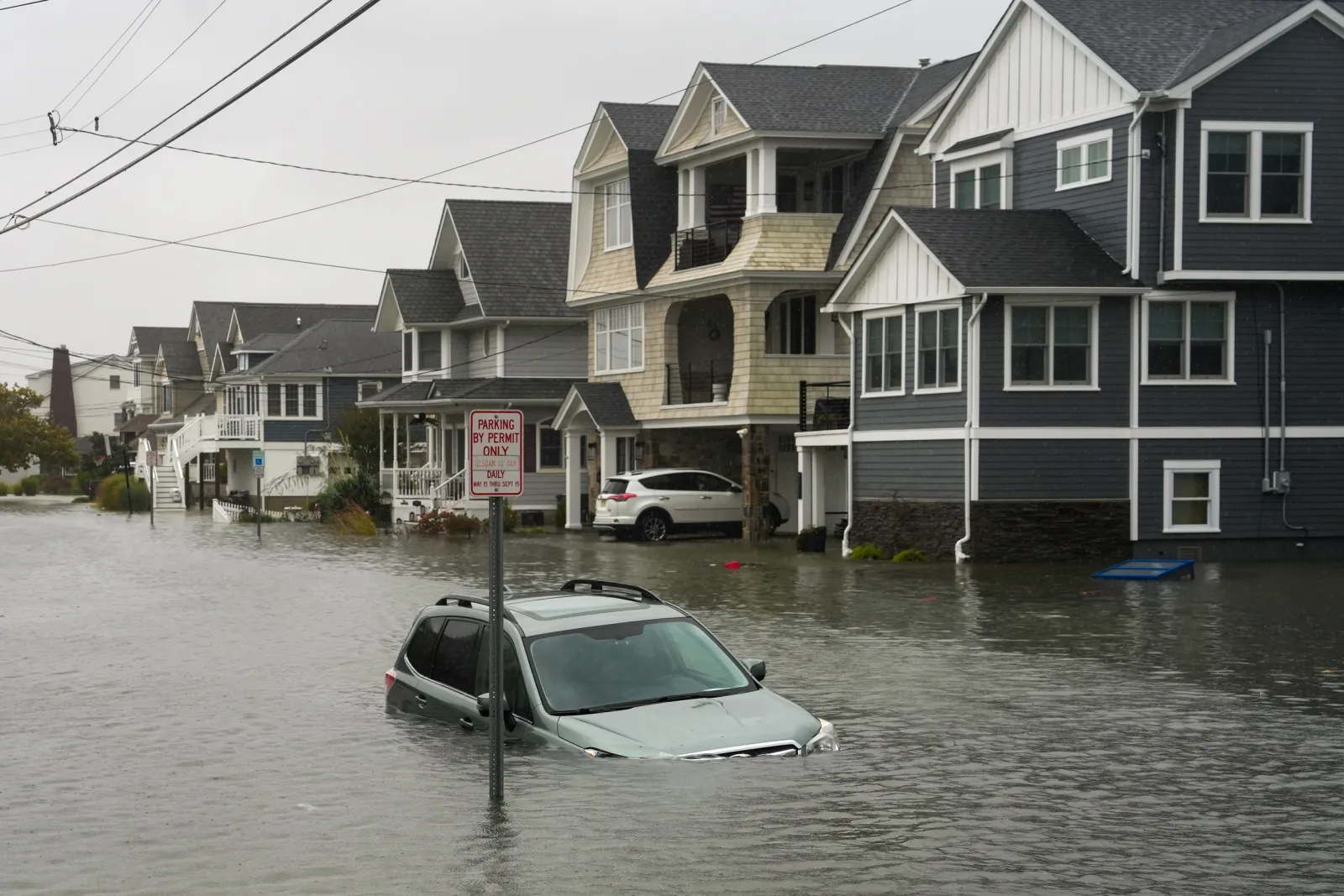 A car is seen submerged in water on a flooded road during a nor'easter storm where a voluntary evacuation has been issued in the community on September 26, 2026 in Point Pleasant, New Jersey.