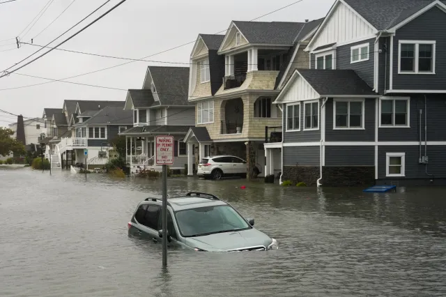 A car is seen submerged in water on a flooded road during a nor'easter storm where a voluntary evacuation has been issued in the community on September 26, 2026 in Point Pleasant, New Jersey.