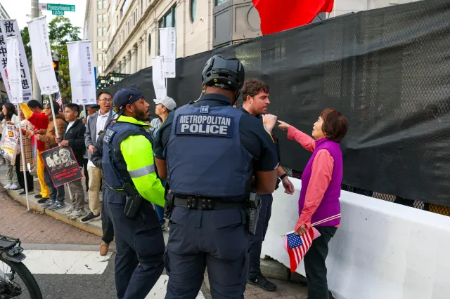 A woman yells at counterprotesters as people gather to celebrate Chinese President Xi Jinping's trip to the United States on Wednesday in Washington, D.C.