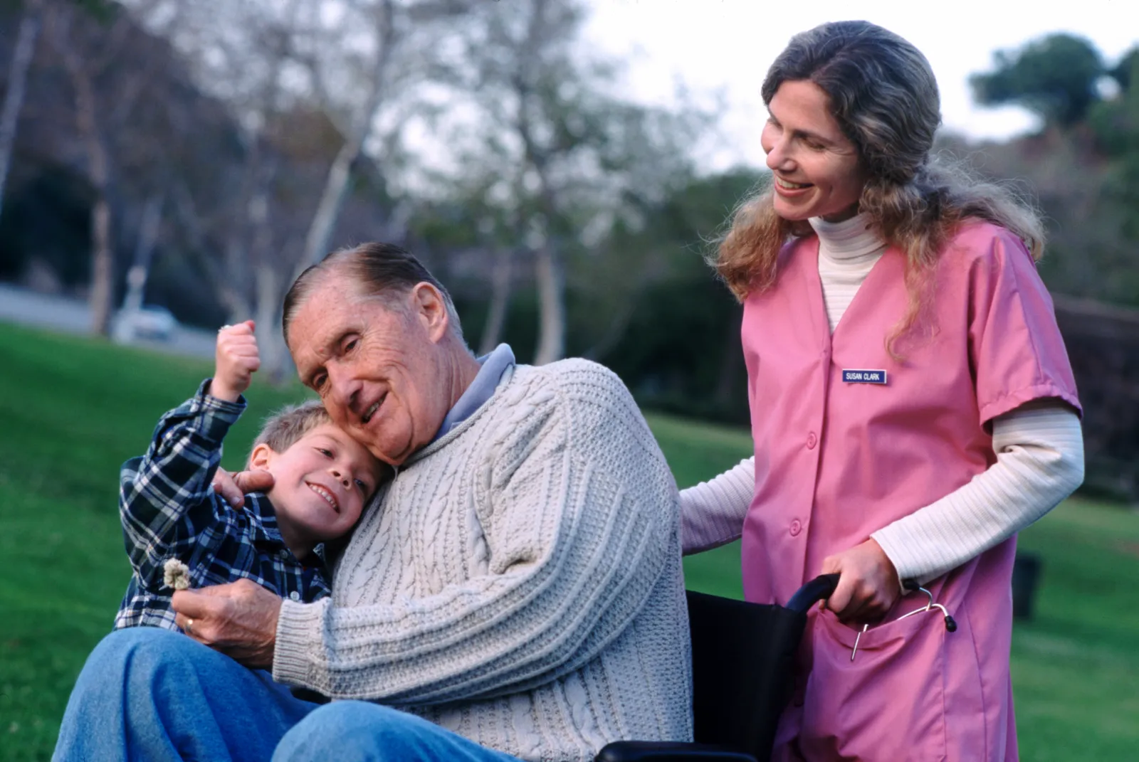 Boy with grandfather and nurse - stock photo