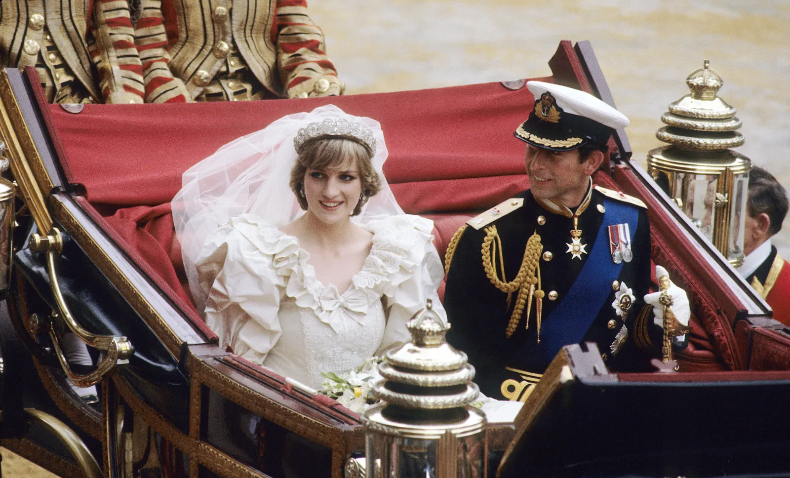 Charles and Diana ride in an open carriage from St. Paul's Cathedral to Buckingham Palace following their wedding on July 29, 1981 in London, England.