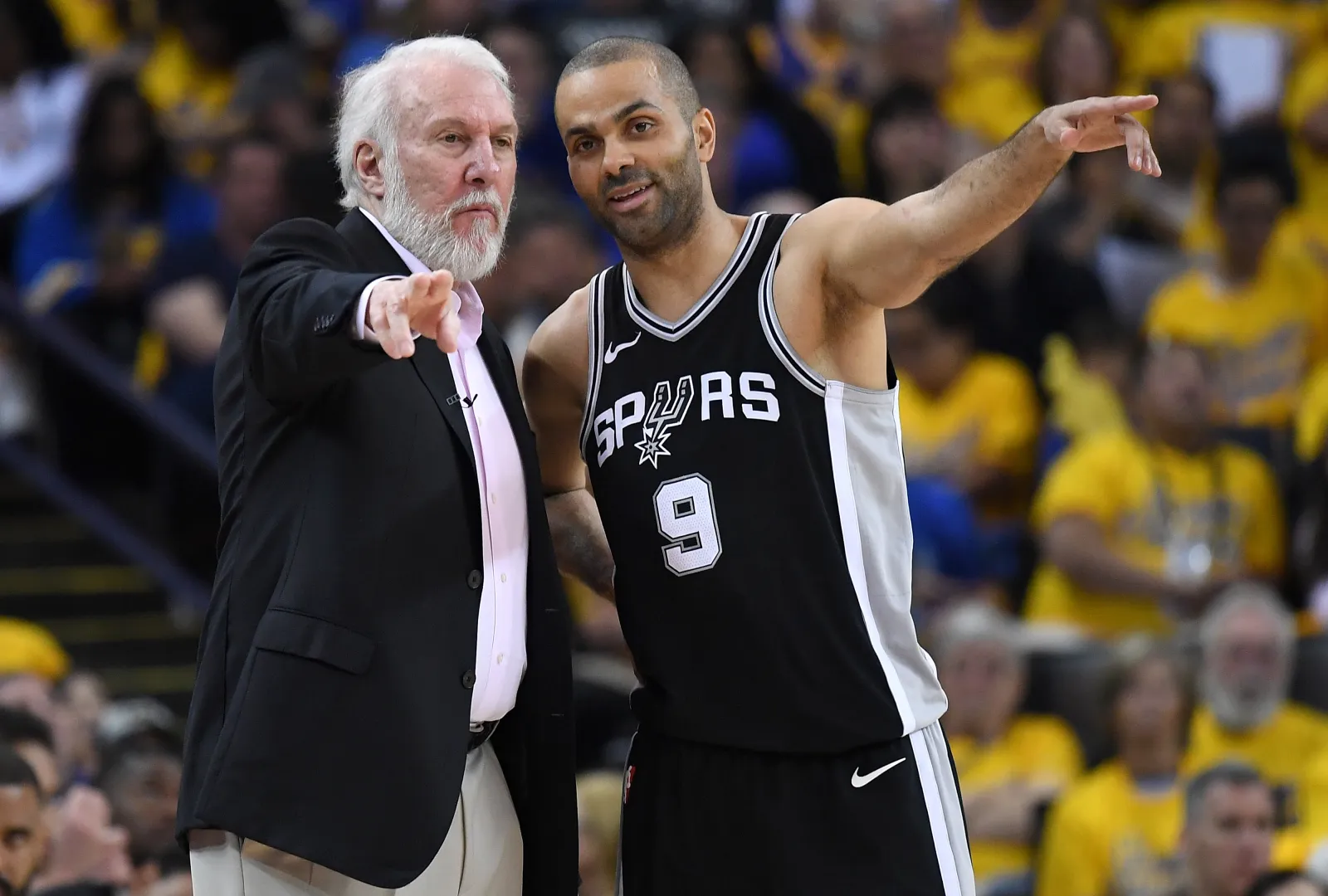 OAKLAND, CA - APRIL 14:  Head coach Gregg Popovich of the San Antonio Spurs talks with his player Tony Parker #9 against the Golden State Warriors in the second quarter during Game One of the first round of the 2018 NBA Playoff at ORACLE Arena on April 14, 2018 in Oakland, California. NOTE TO USER: User expressly acknowledges and agrees that, by downloading and or using this photograph, User is consenting to the terms and conditions of the Getty Images License Agreement.  (Photo by Thearon W. Henderson/Getty Images)