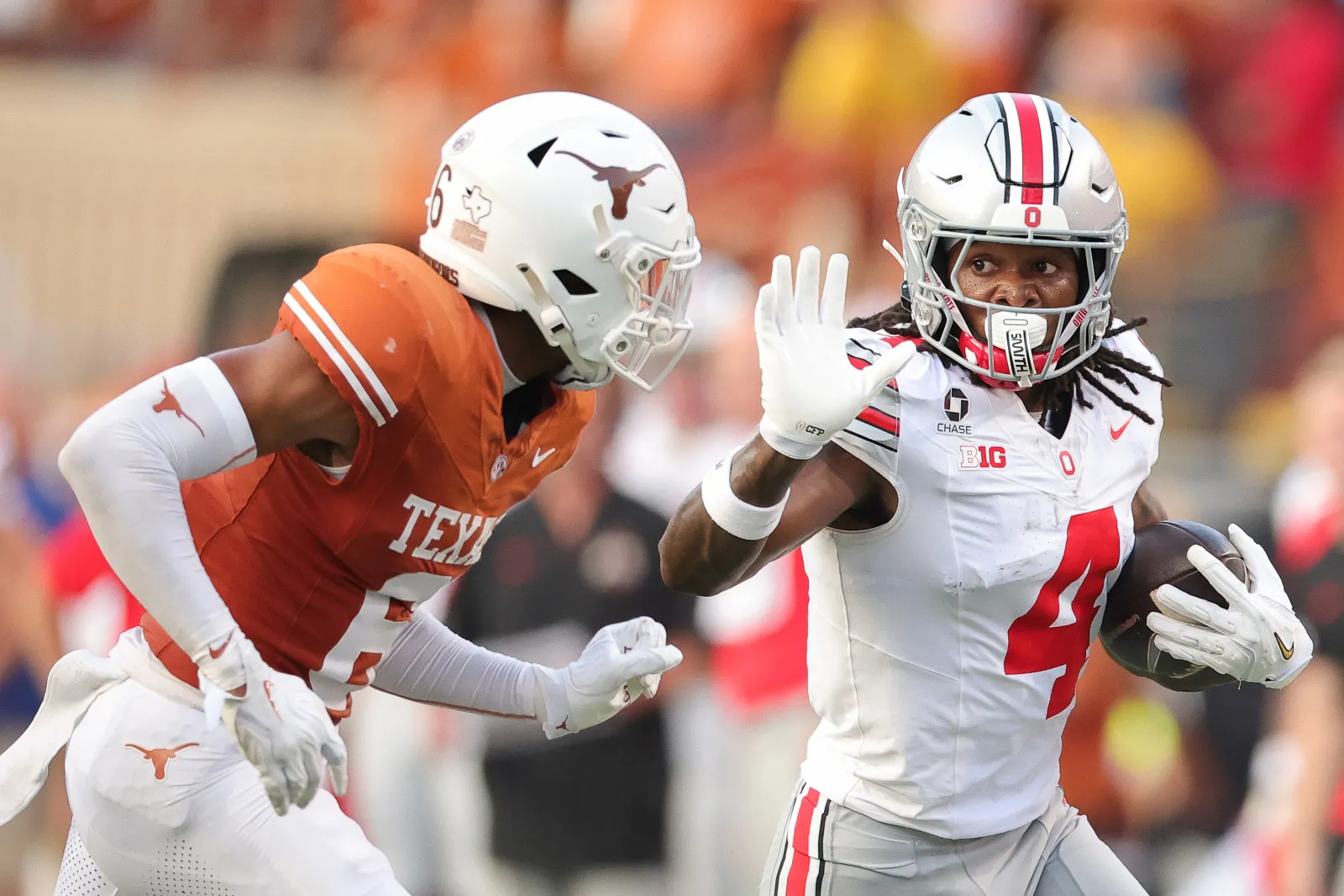 AUSTIN, TEXAS - SEPTEMBER 12: Jeremiah Smith #4 of the Ohio State Buckeyes carries the ball against Kobe Black #6 of the Texas Longhorns during the first quarte
