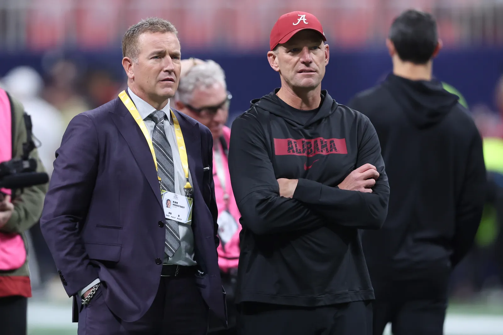 ATLANTA, GEORGIA - DECEMBER 06: (L-R) Sportscaster Kirk Herbstreit and Head coach Kalen Deboer of the Alabama Crimson Tide look on prior to the 2025 SEC Champio