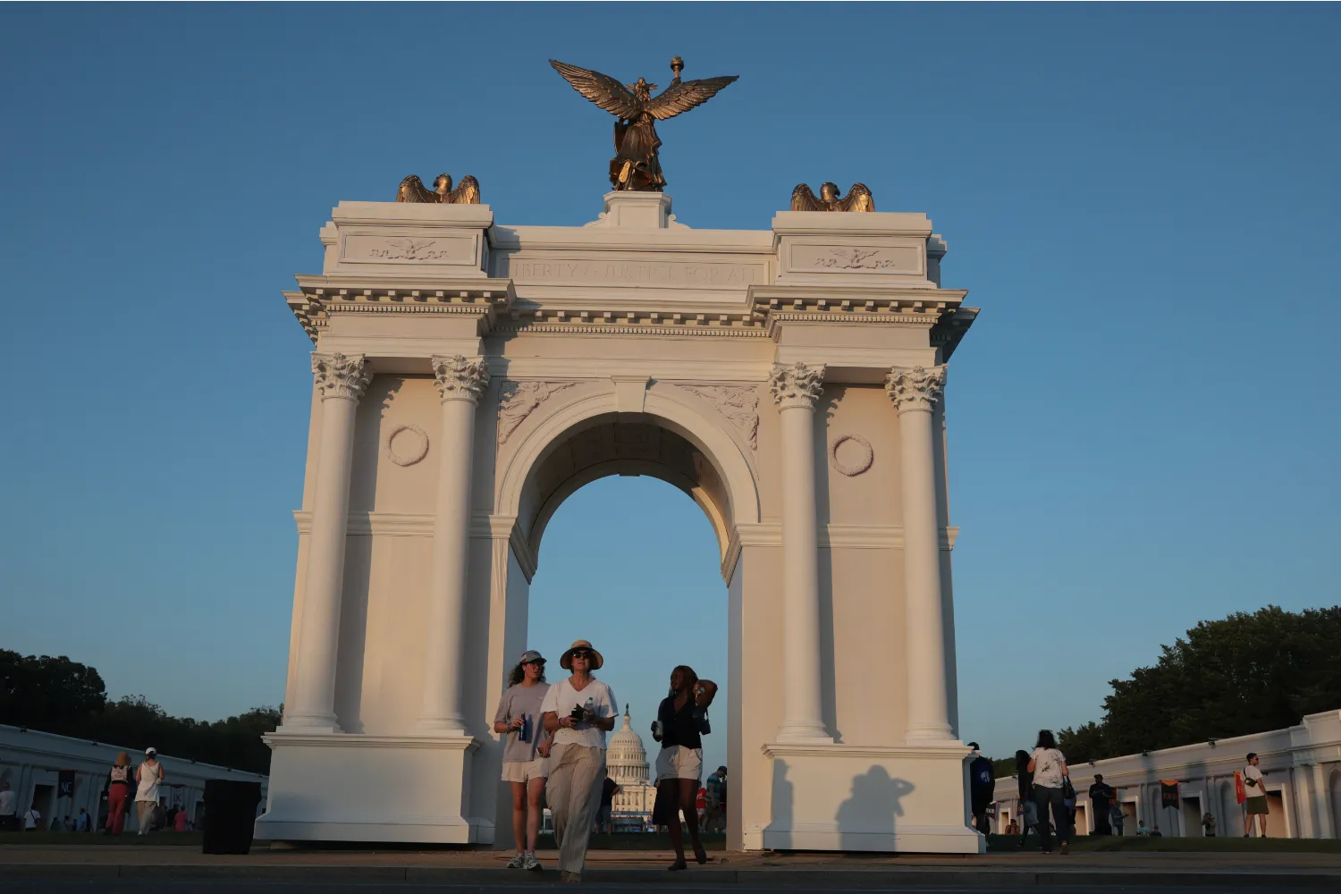 Visitors walk near a replica of President Trump's planned "Triumphal Arch" at the Great American State Fair on July 02, 2026 in Washington, DC.
