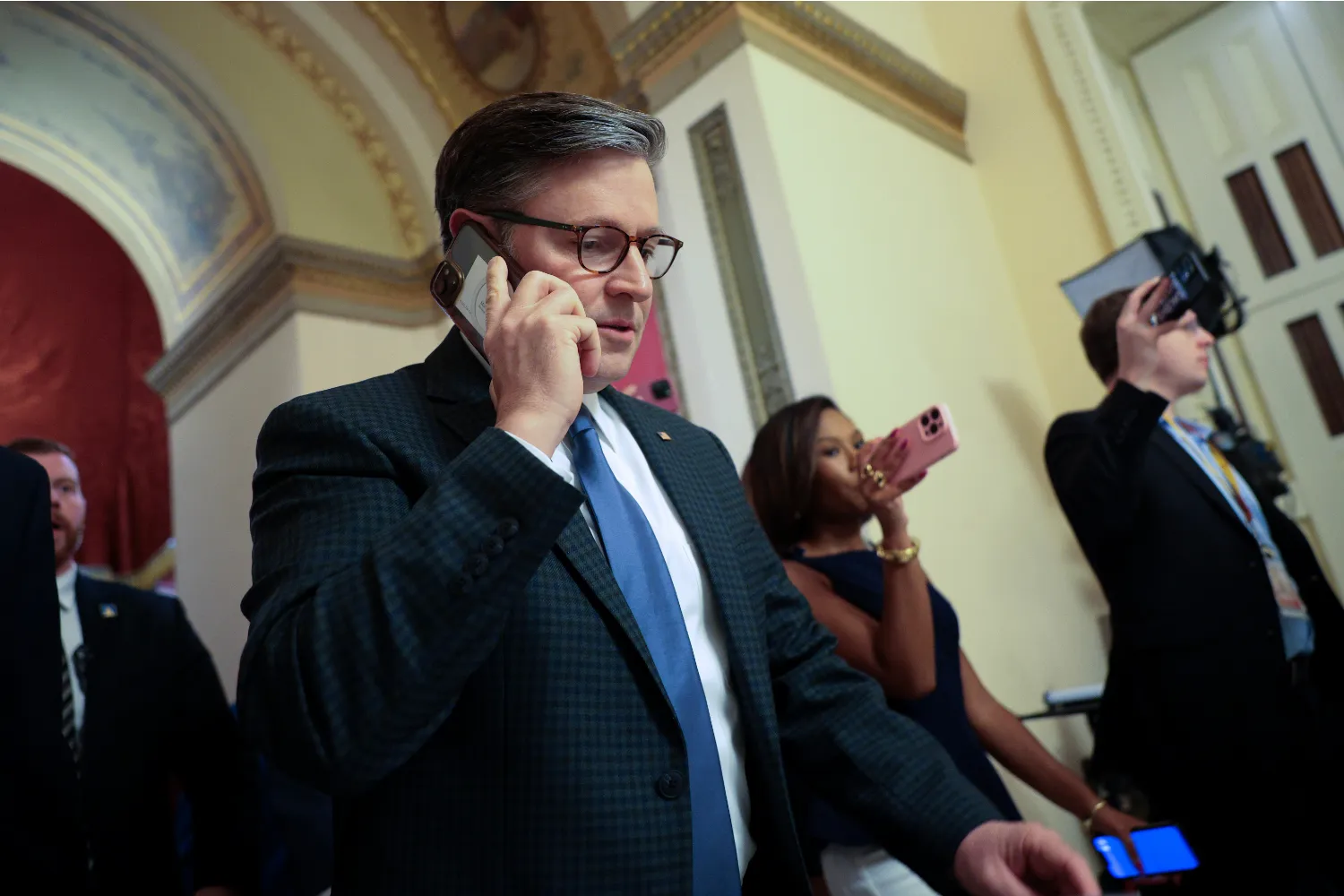 U.S. Speaker of the House Mike Johnson (R-LA) talks on the phone as he walks from his office to the House chamber at the U.S. Capitol on September 14, 2026 in W