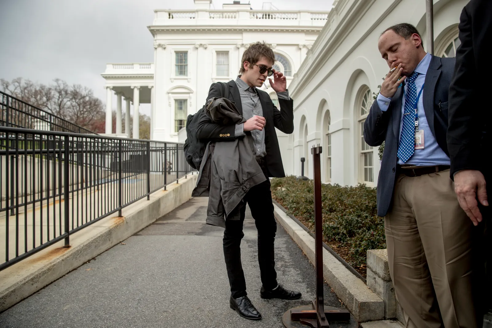 White House correspondent for the right-wing blog Gateway Pundit Lucian Wintrich, center, and White House correspondent for Russian-owned Sputnik News Service Andrew Feinberg, right, stand outside the White House briefing room at the White House on March 10, 2017, in Washington.
