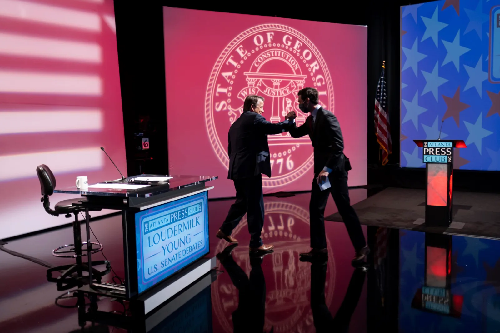 Democratic challenger Jon Ossoff, right, thanks moderator Russ Spencer following a debate for U.S. Senate on Sunday, Dec. 6, 2020, in Atlanta. Sen. David Perdue declined to attend the debate. (AP Photo/Ben Gray, Pool)