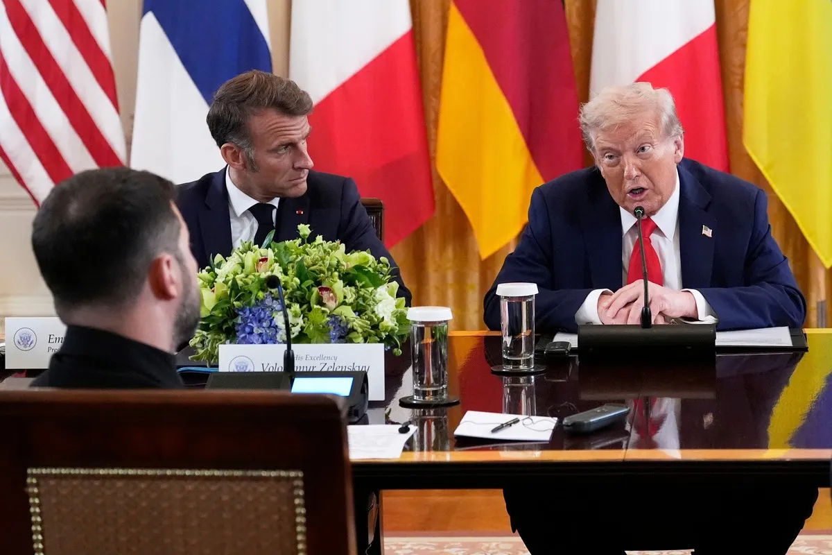 President Donald Trump speaks as France's President Emmanuel Macron listens during a meeting with Ukrainian President Volodymyr Zelenskyy, foreground left, and European leaders in the East Room of the White House, Aug. 18, 2025, in Washington.