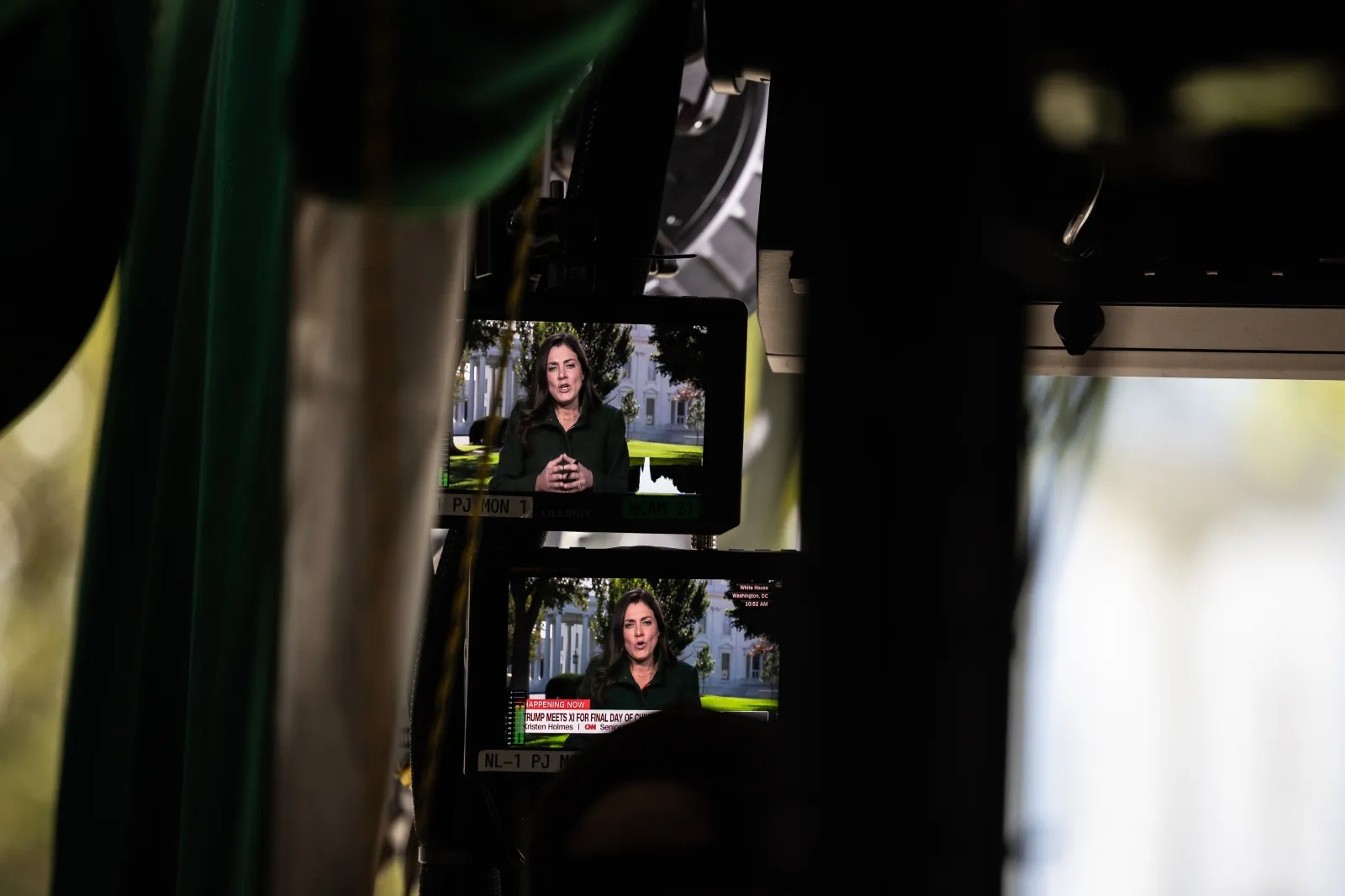 CNN senior White House correspondent Kristen Holmes is seen on a pair of monitors as she films a live segment in a tent on the "Pebble Beach" press area outside the White House on Sept. 25, 2026. (Francis Chung/POLITICO via AP Images)